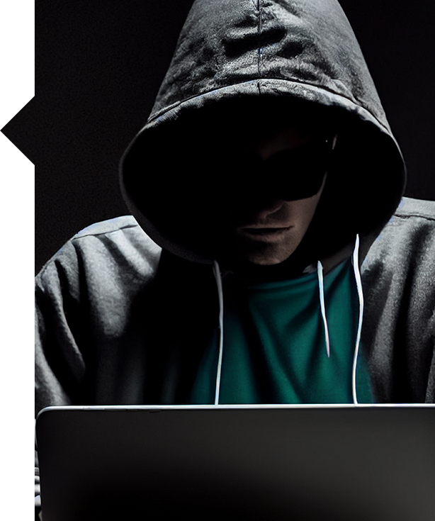 Hooded figure using laptop